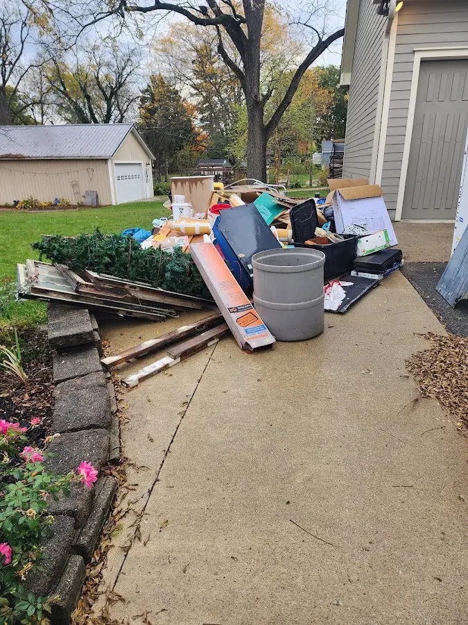Dumpster being loaded with debris for Commercial Dumpster Rental in University
